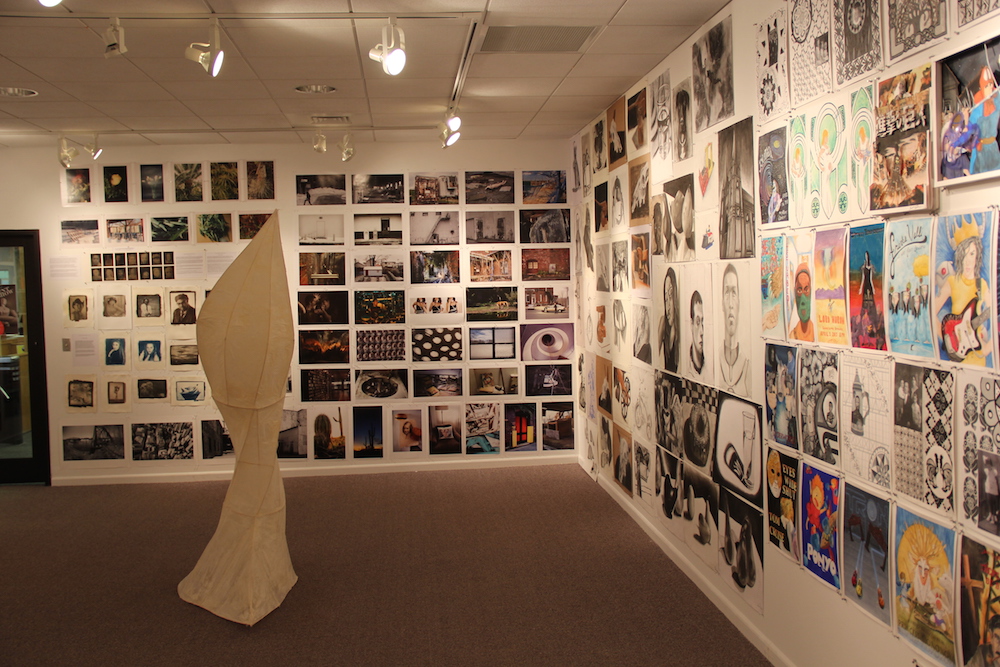 Taber Art Gallery walls displaying several student works of art